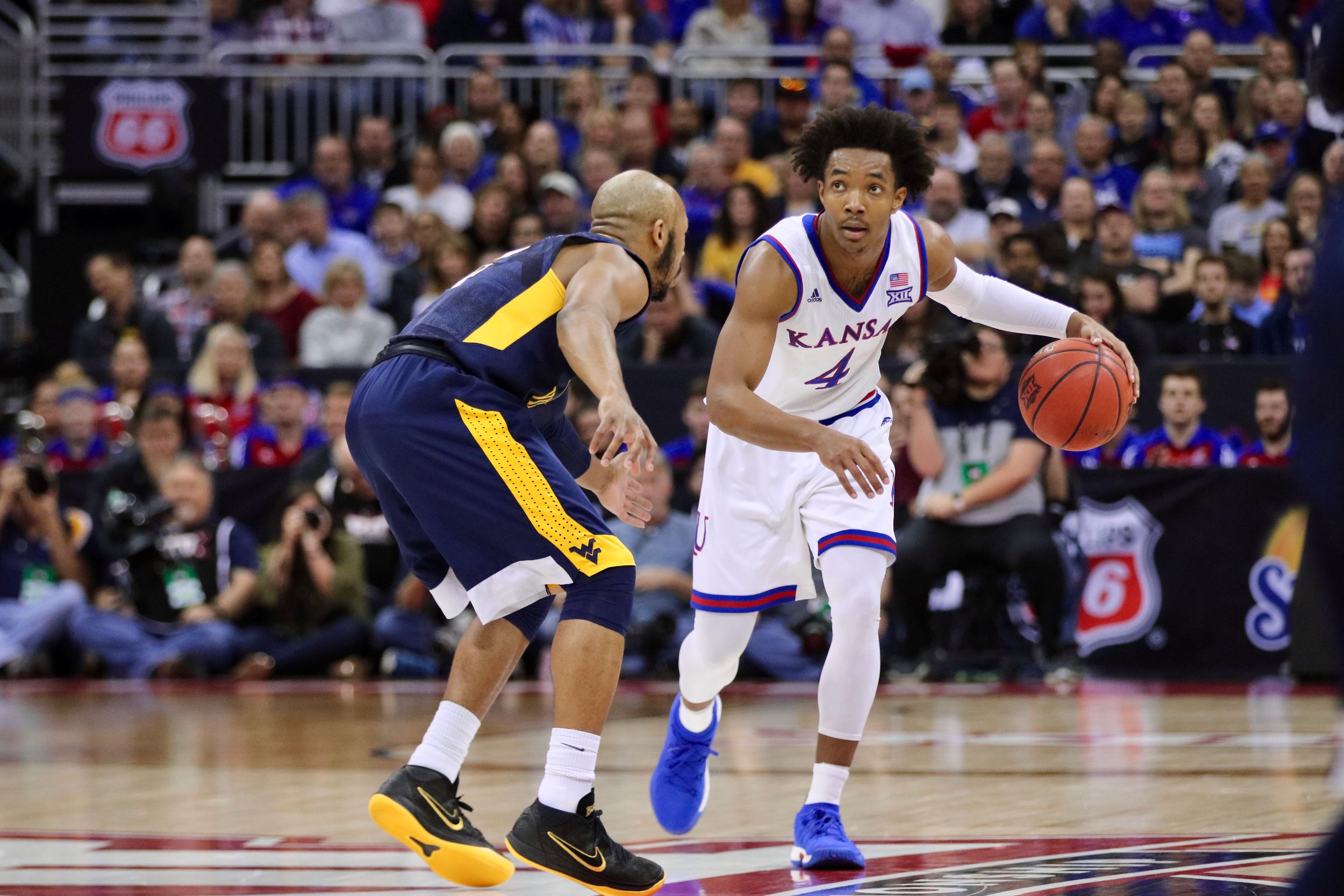 Basketball players from opposing teams face off during an intense professional game.