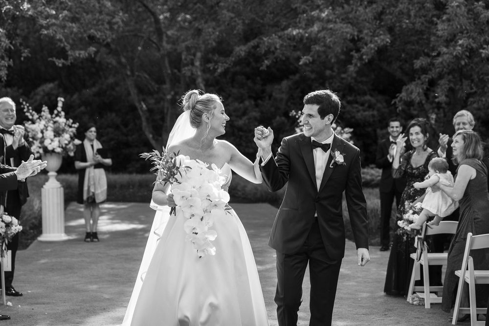 Bride and groom laughing happily exiting ceremony at Brantwyn at a delaware wedding