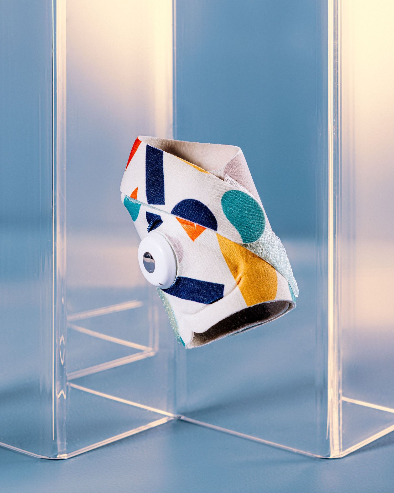 Colorful patterned disposable face mask displayed on clear acrylic dividers.