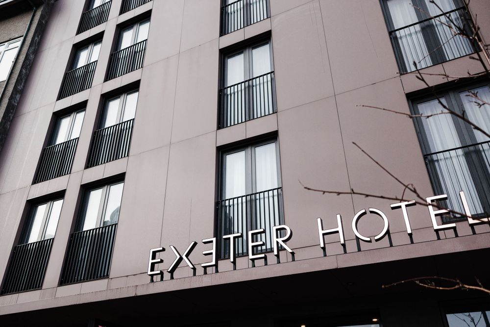 Exterior view of the Exeter Hotel building facade with modern architectural details.