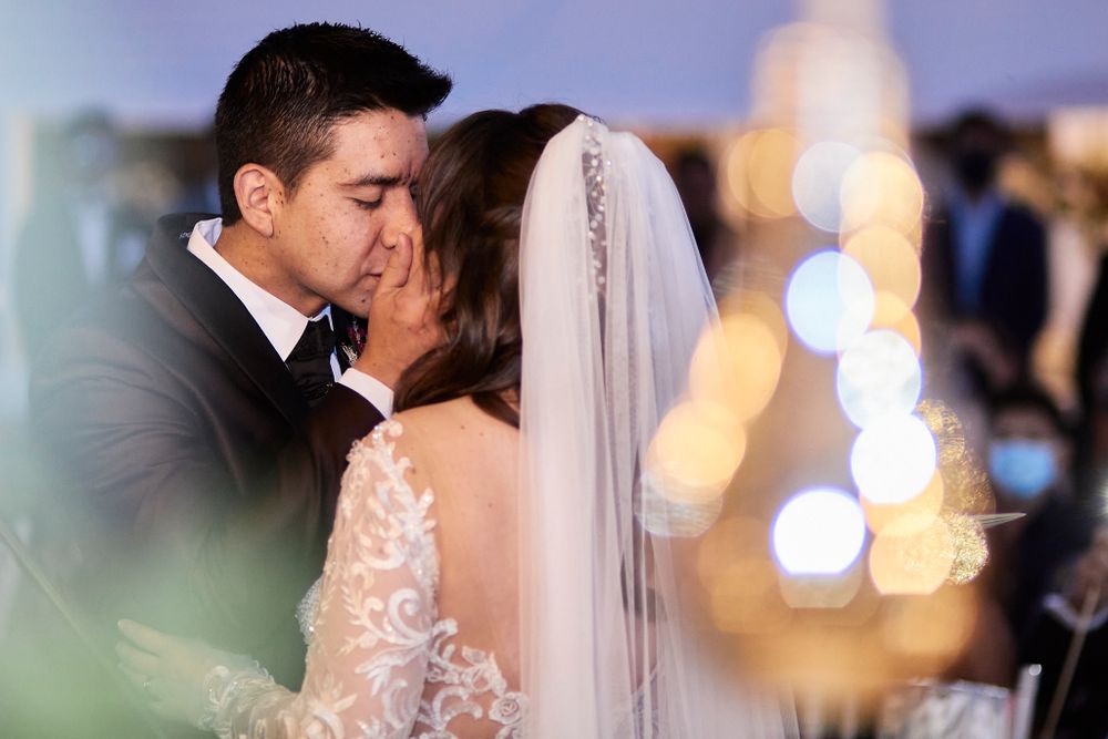 A close-up shot of a couple sharing a tender moment during their wedding ceremony.