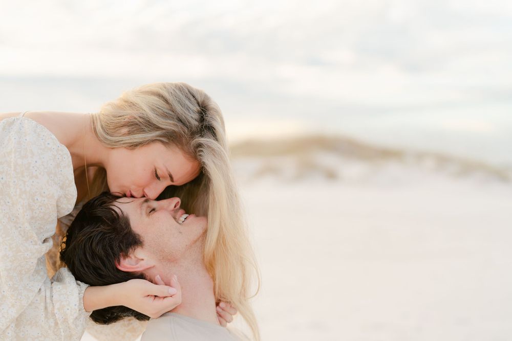 An intimate close-up of a couple sharing a romantic moment on the beach.