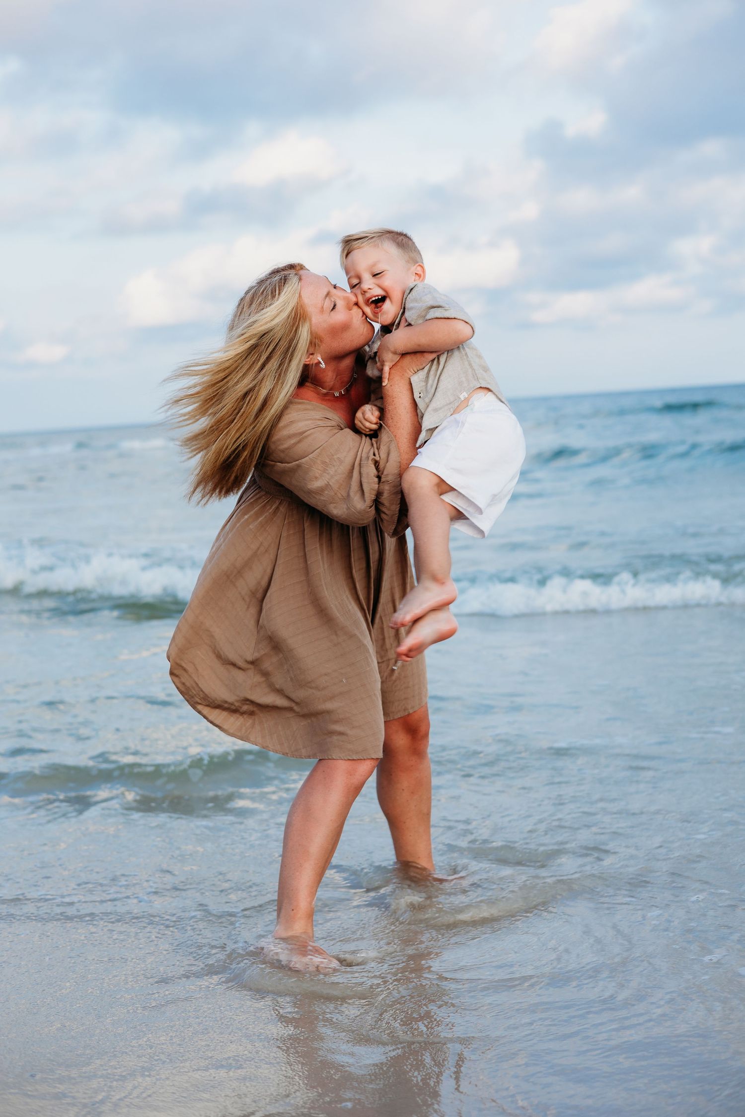 Playful moments captured at the ocean's edge during golden hour.