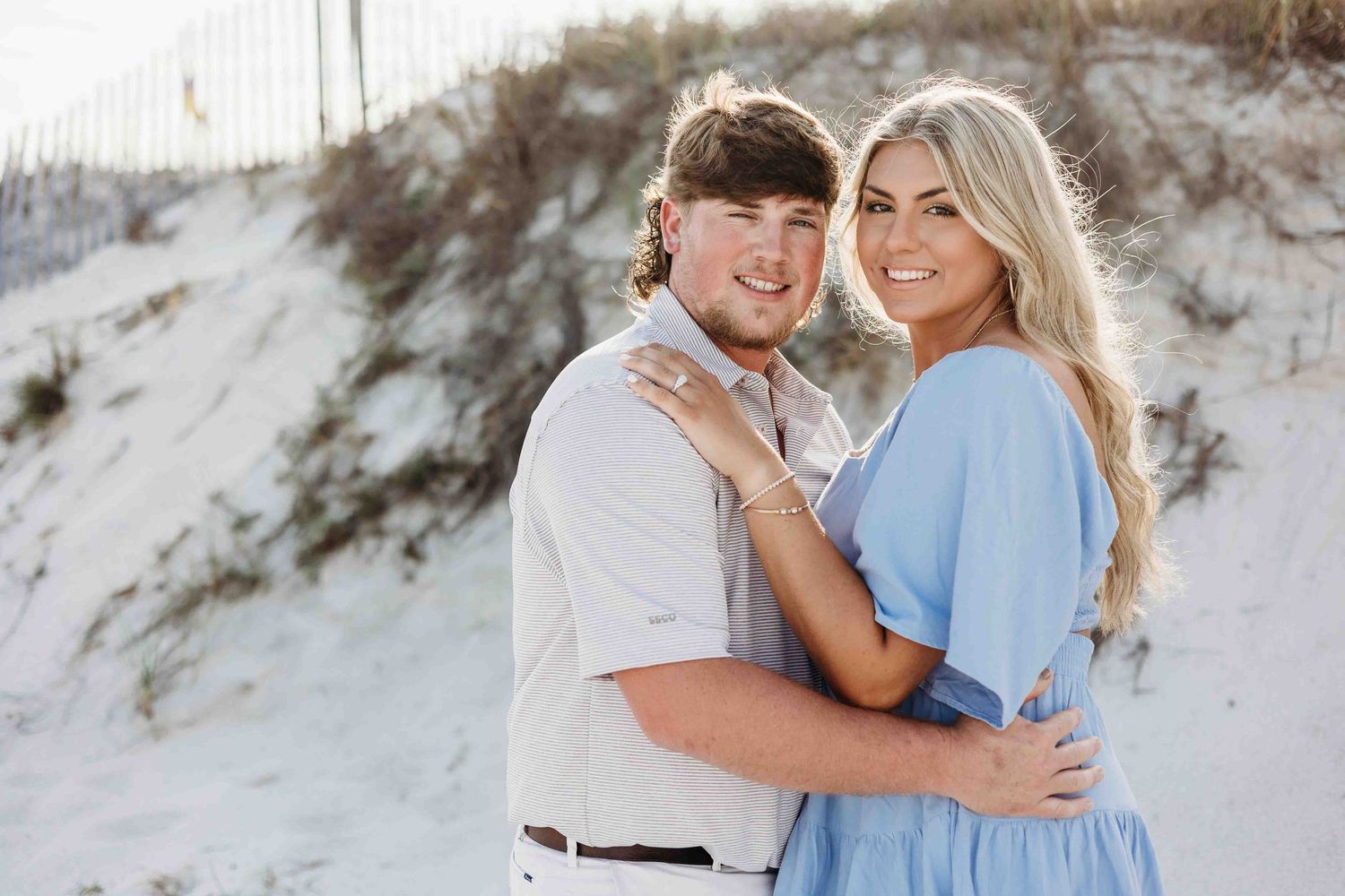 Beachside engagement photos showing tender moments between two people in casual attire.