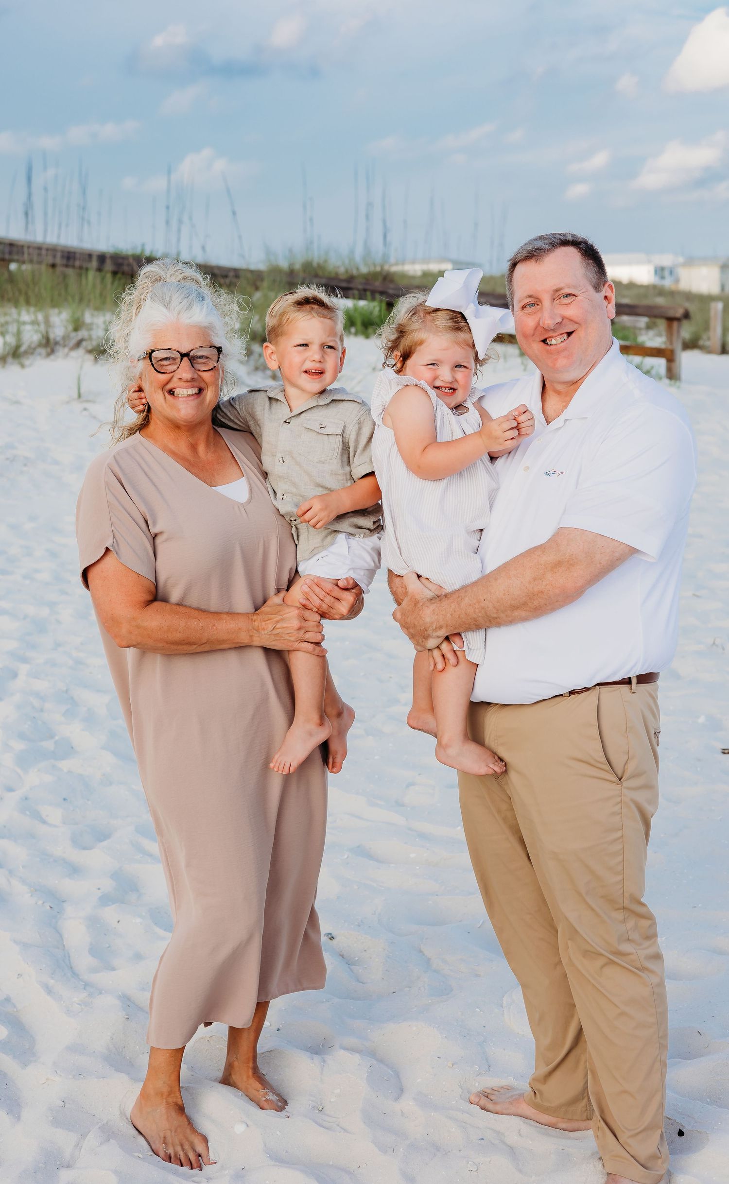 Family members laugh together during a relaxed beach photography session.