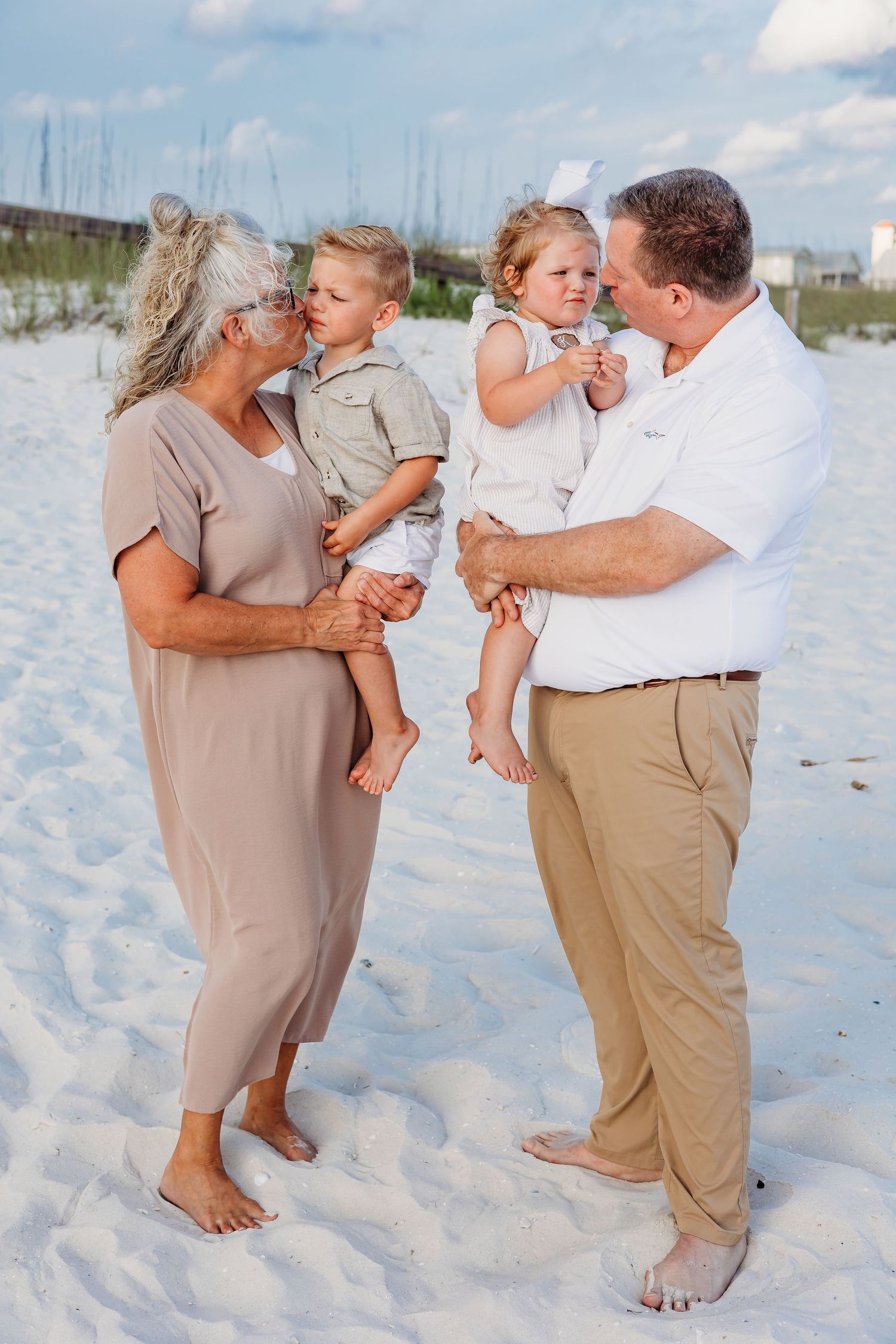 Playful family interactions photographed on a scenic white sand beach.