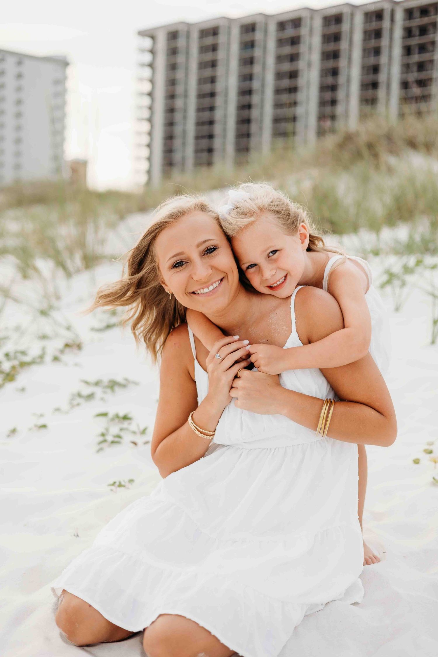 Loving embraces between parent and child captured in a series of beach photos.