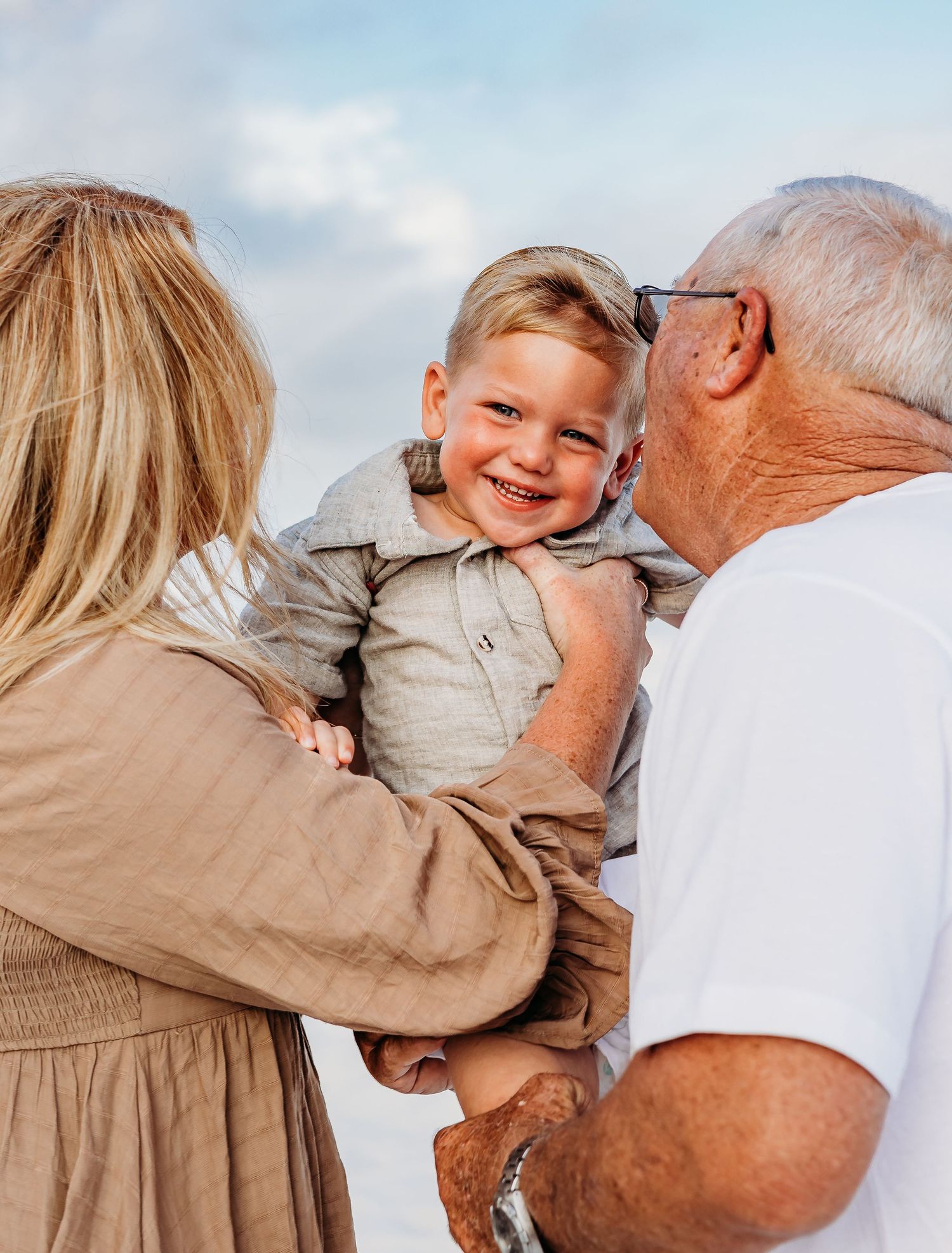Heartwarming family moments captured in a series of playful interactions on the beach.
