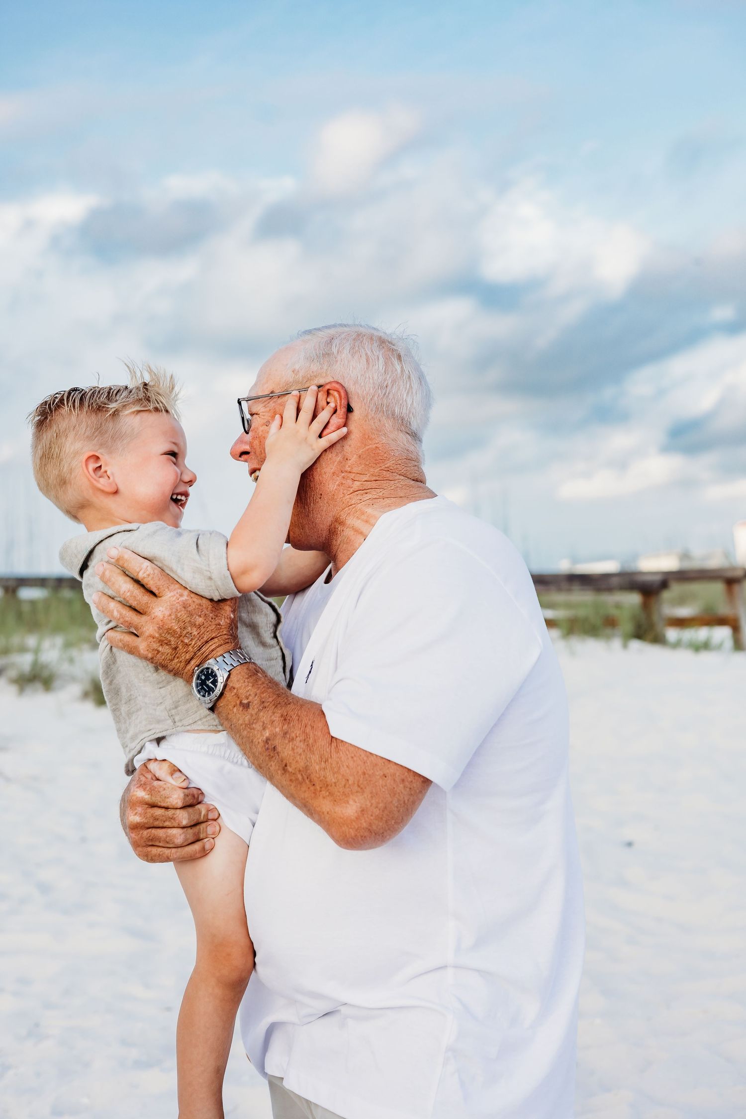 Heartwarming moments shared between generations on a bright beach setting.