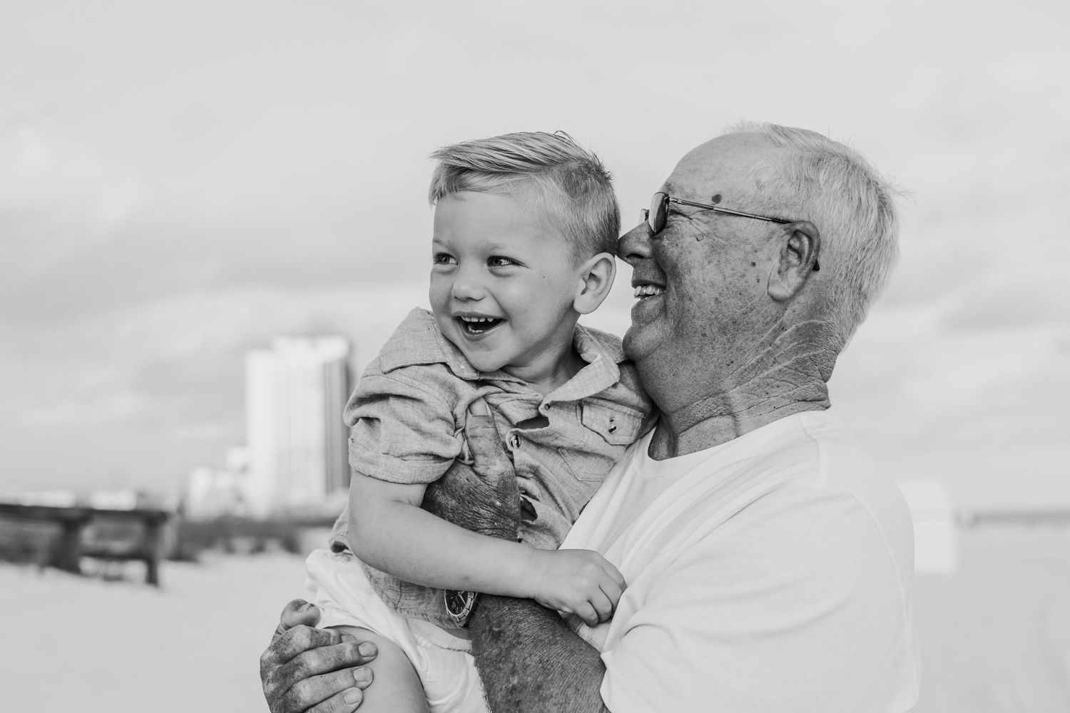 Black and white captures of pure joy between family members at the beach.