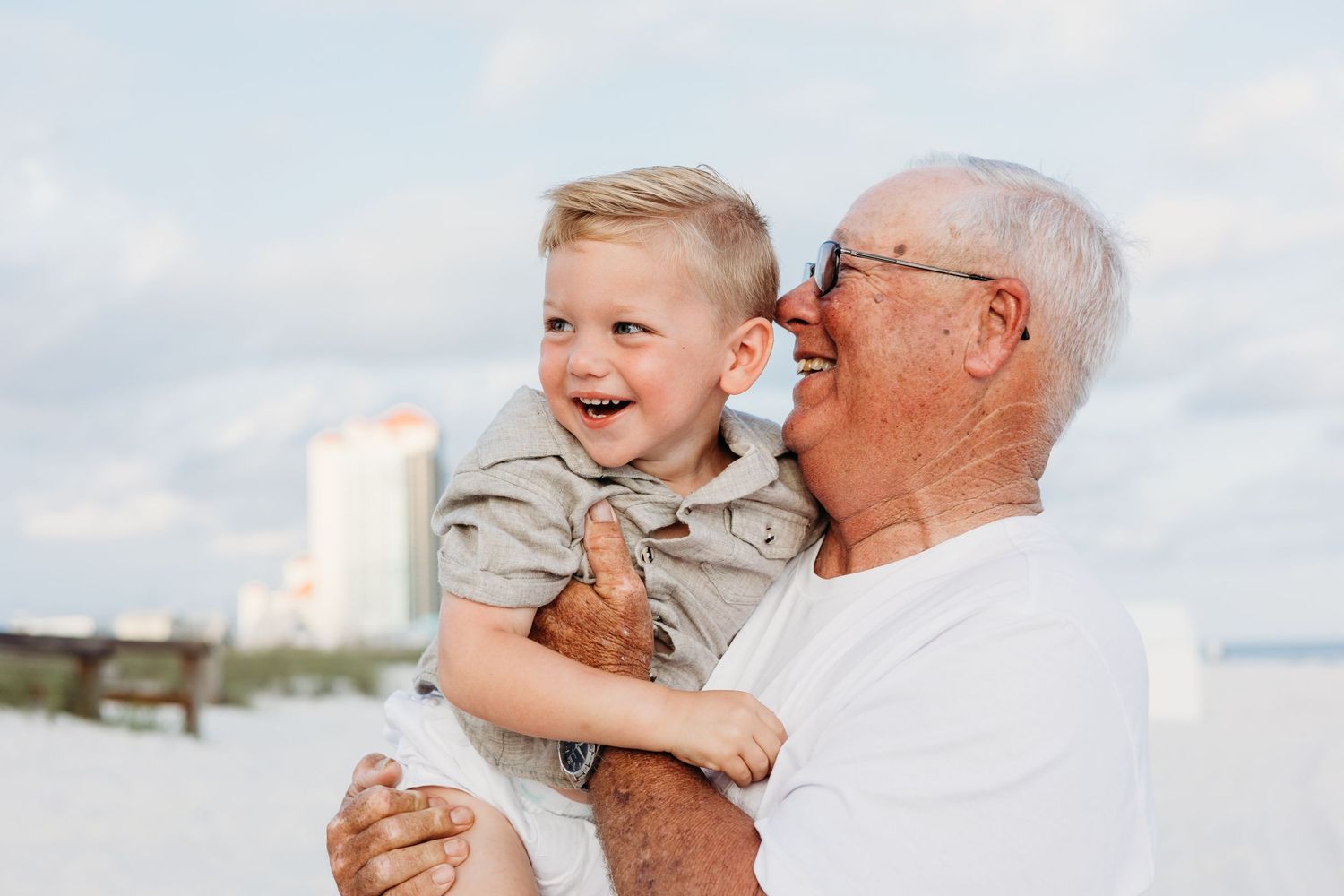 Sweet candid moments of intergenerational bonding against a bright sky.