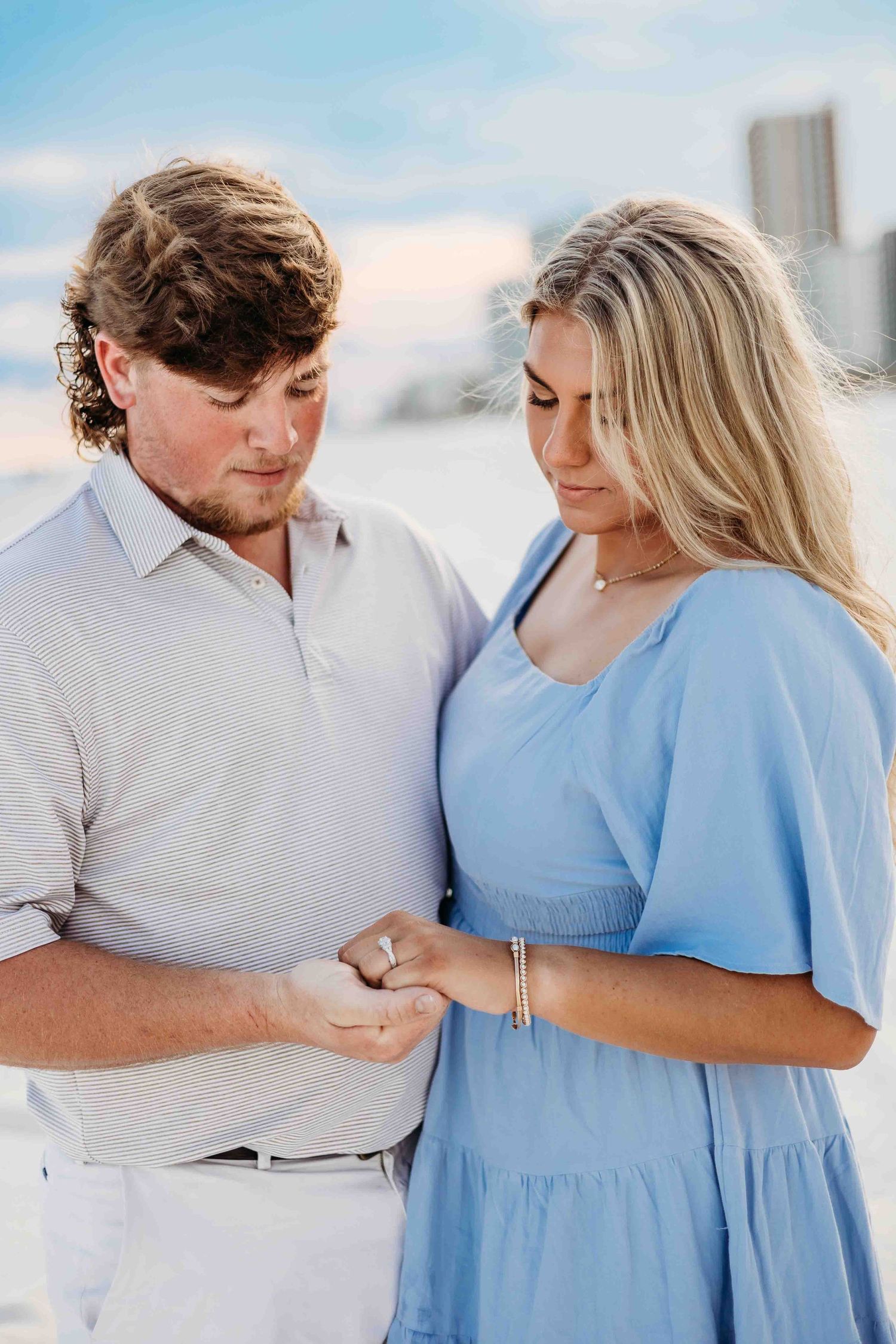 Close-up shots of couple sharing tender moments in coordinated beach attire.