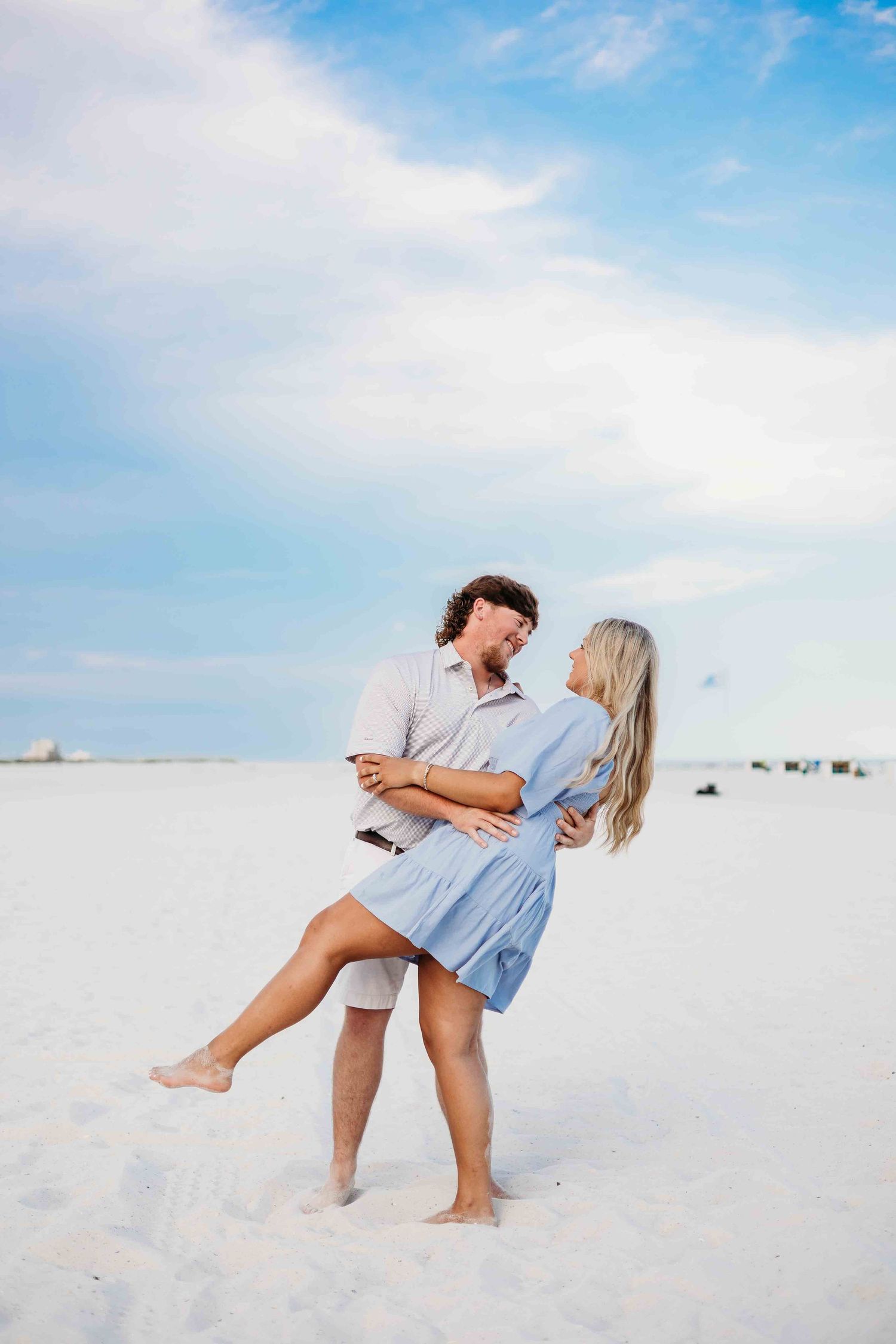 Couple shares romantic dance moves on pristine white sand beach.