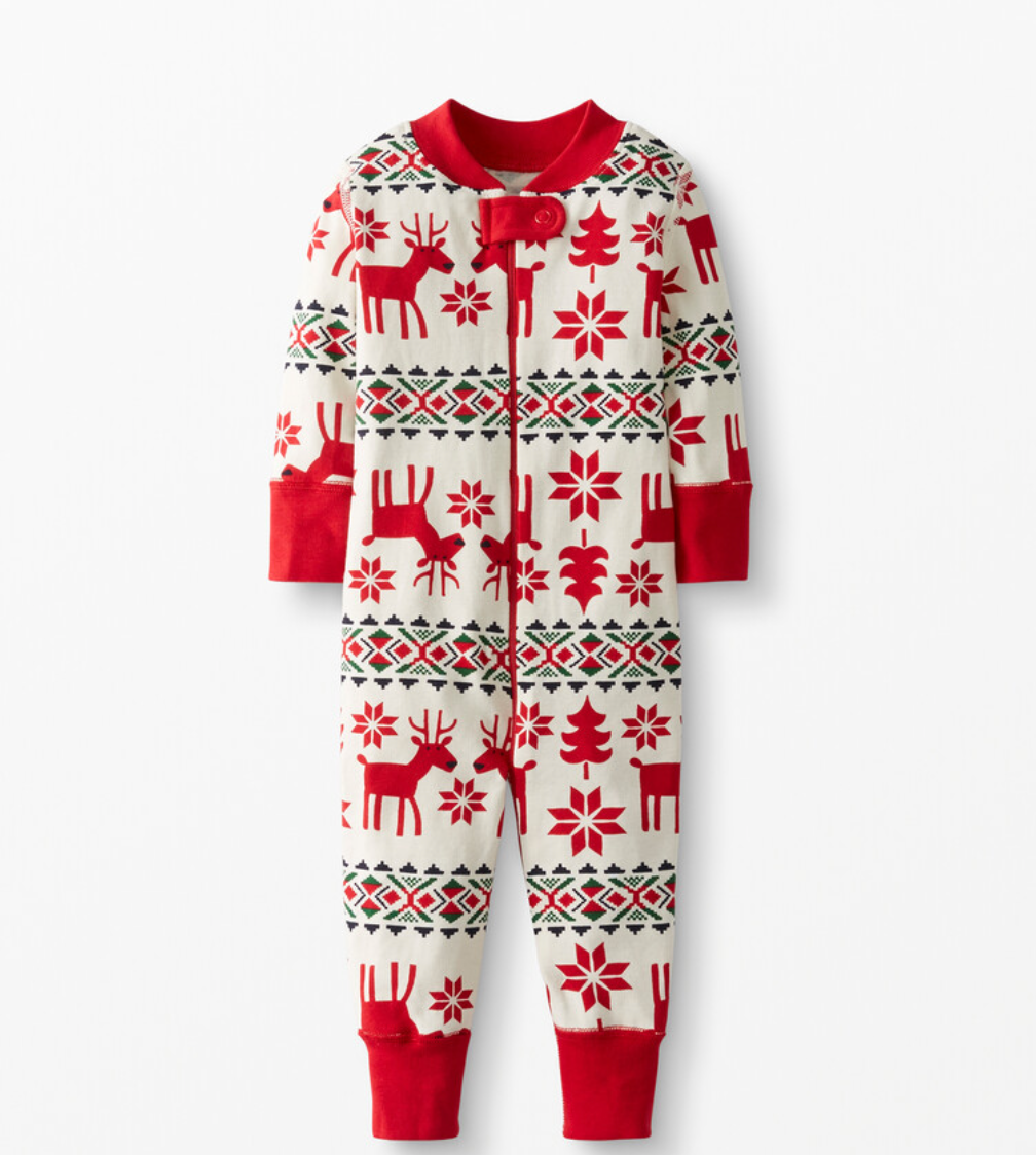 Red and white Nordic pattern Christmas pajamas with reindeer and snowflake designs.