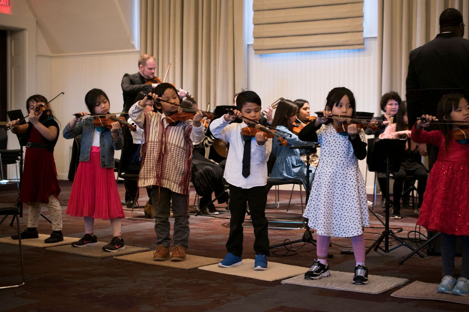 Students from The Buffalo String Works putting on a concert for the people of the Elmwood Village at Hotel Henry