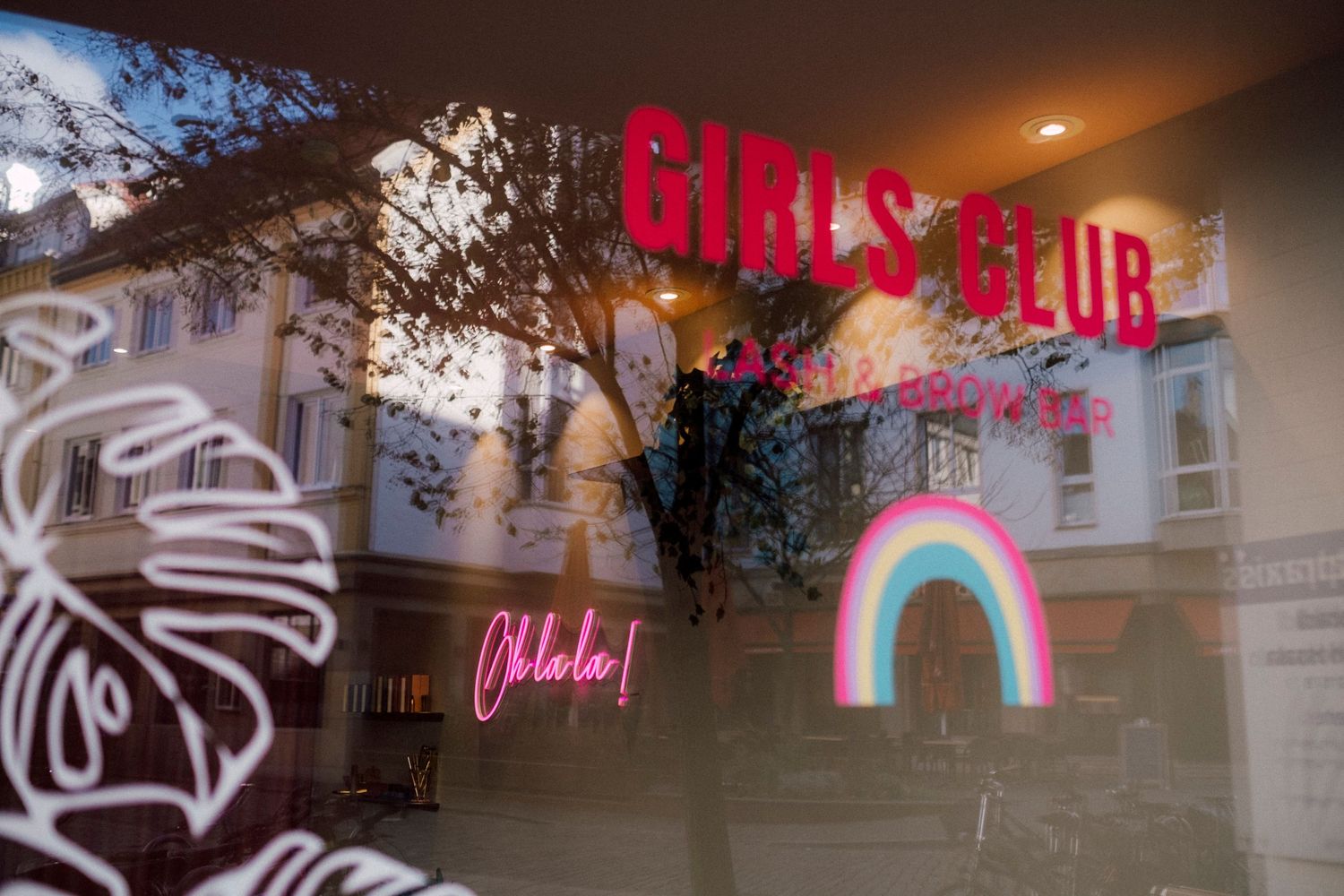Neon signs and storefront displays lit up at night with glowing effects.