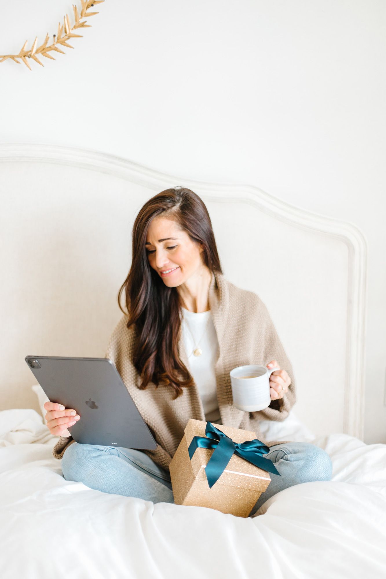 Cozy lifestyle photos of relaxing in bed with tablet and coffee.