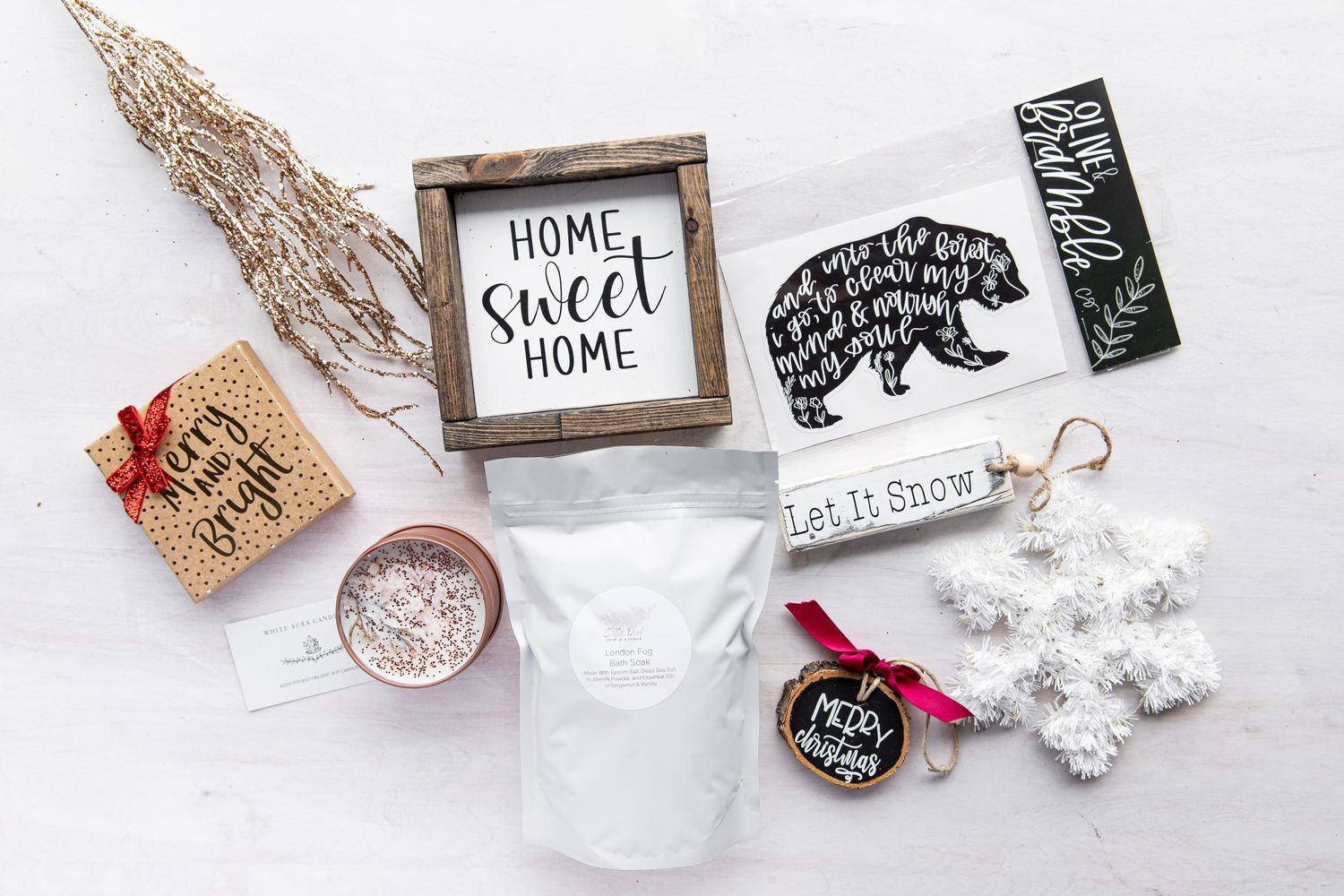 Flat lay of rustic home decor items including wooden frames and holiday decorations.