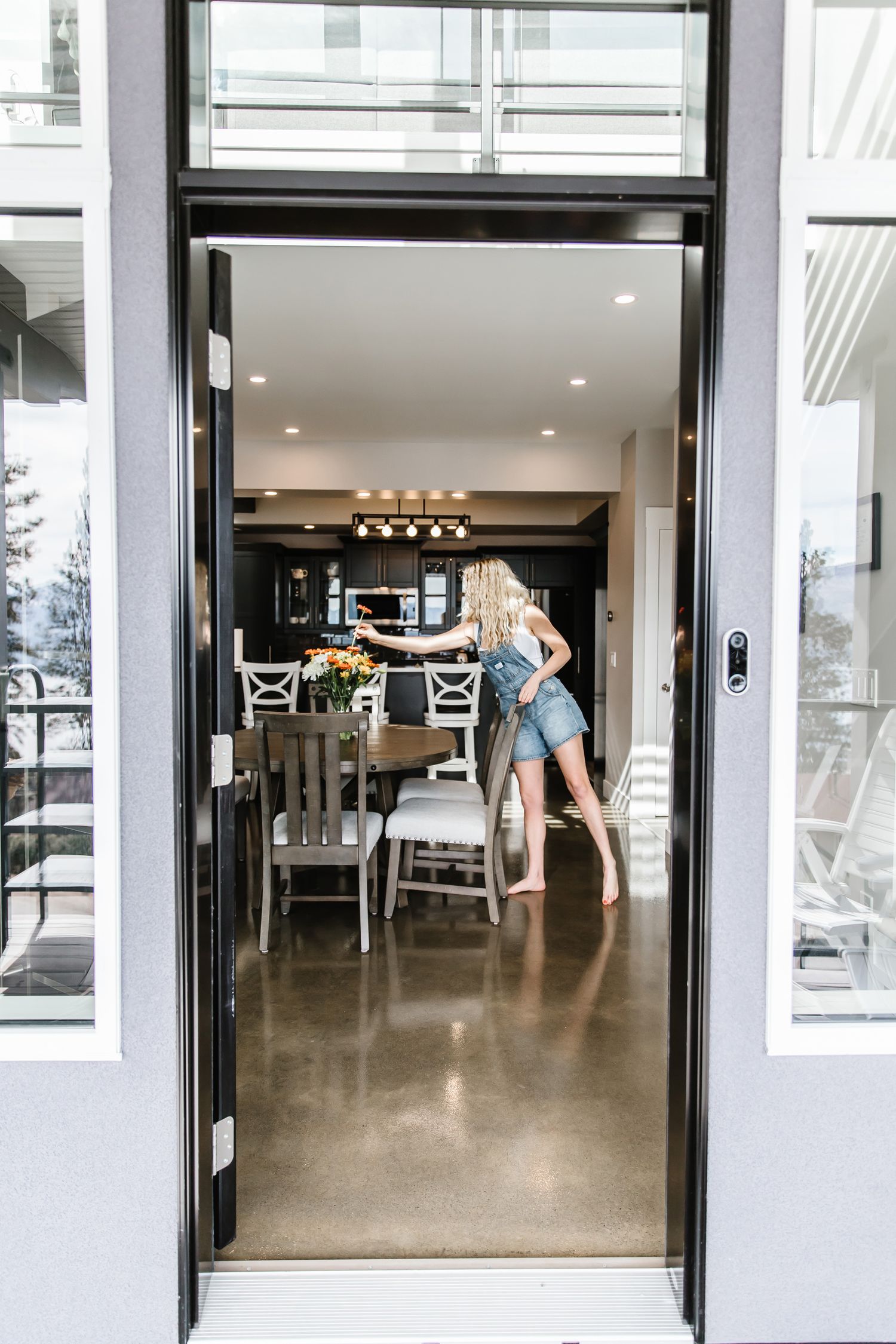 Modern commercial space with glass doors and concrete floors in bright lighting.