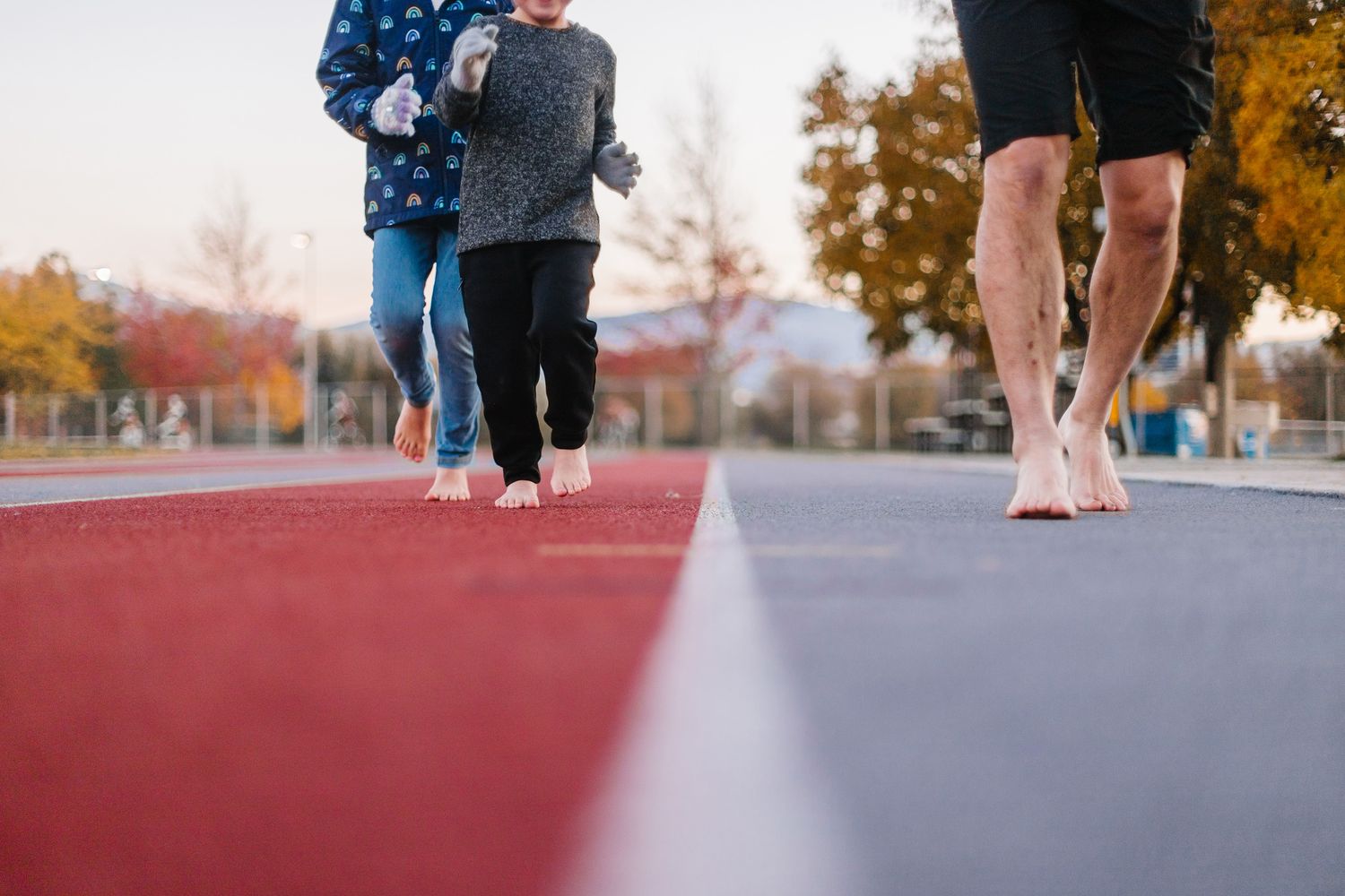 Low angle view of runners' feet on athletic track during workout.