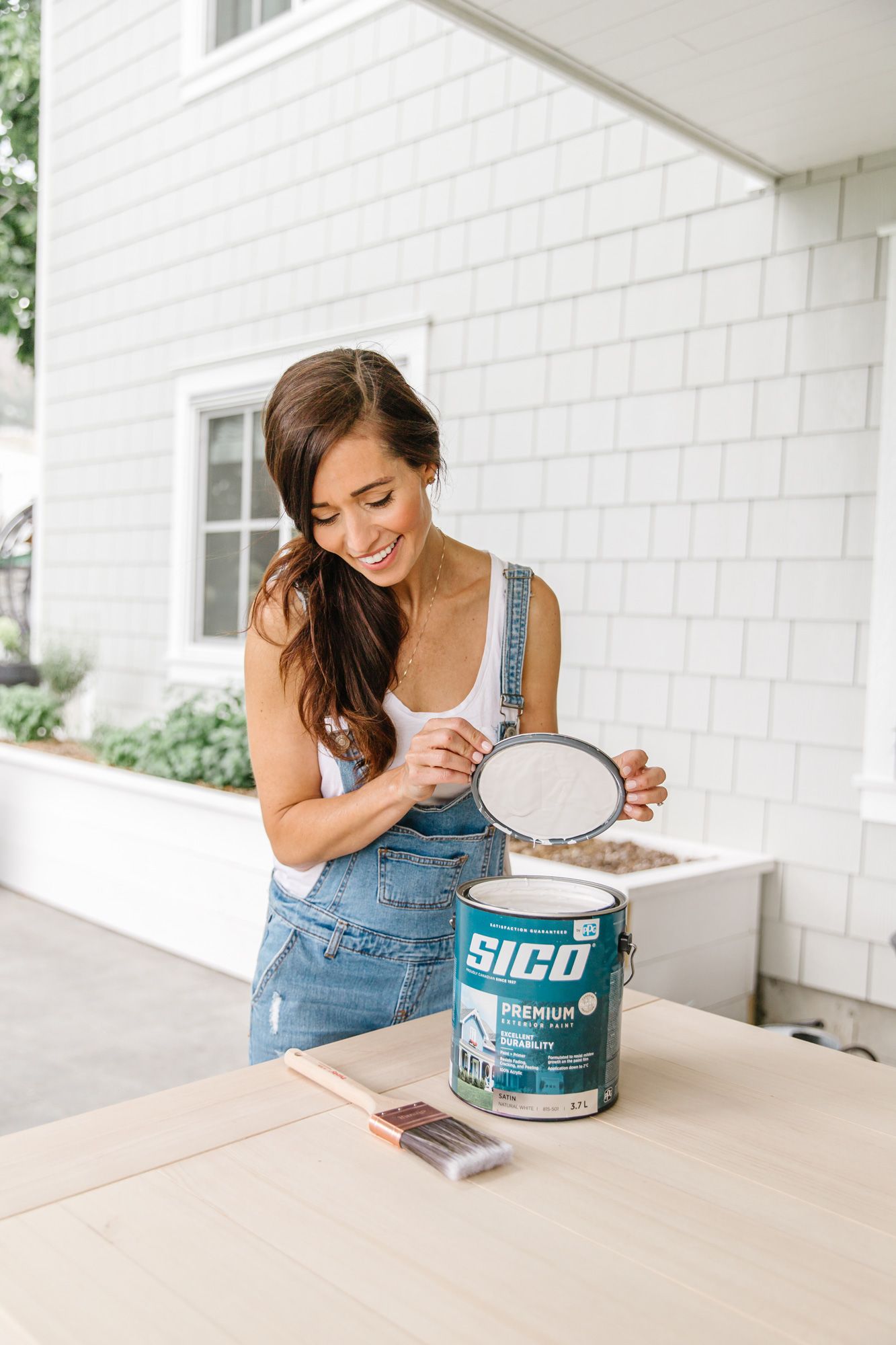 DIY home improvement project with paint can and supplies on outdoor table.