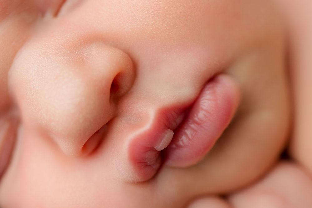 Extreme close-up of a sleeping newborn's nose and lips.
