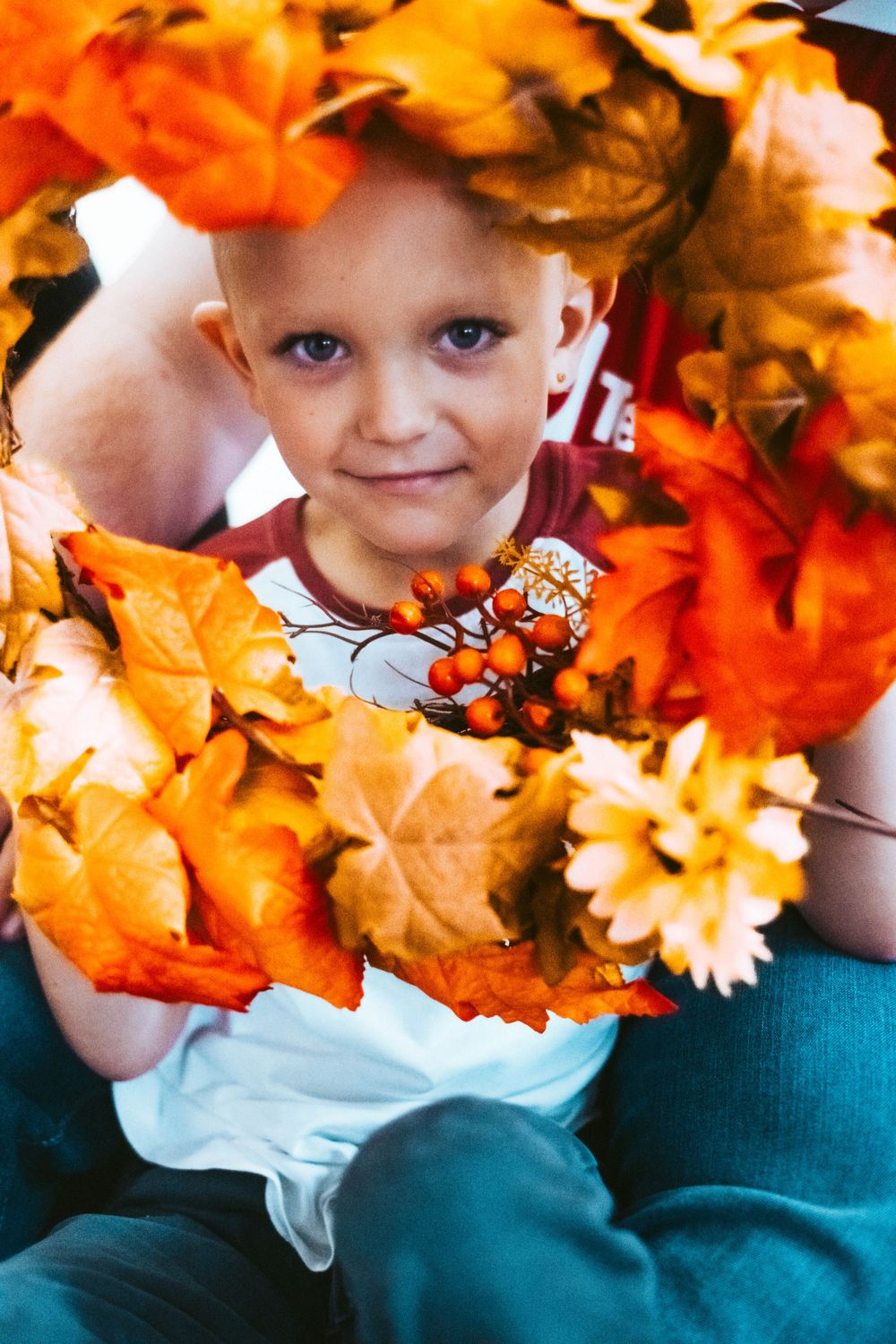 Autumn portrait surrounded by vibrant orange maple leaves.