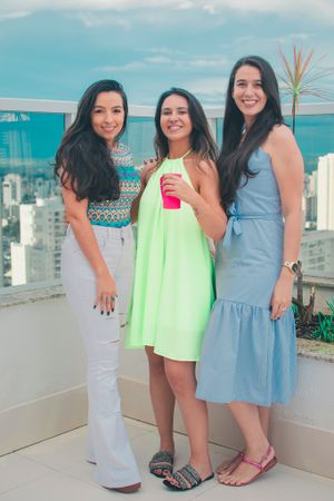 Casual group photos at a rooftop party featuring summer dresses and city views.