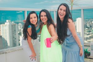 Friends celebrating on a modern rooftop terrace with panoramic city views.