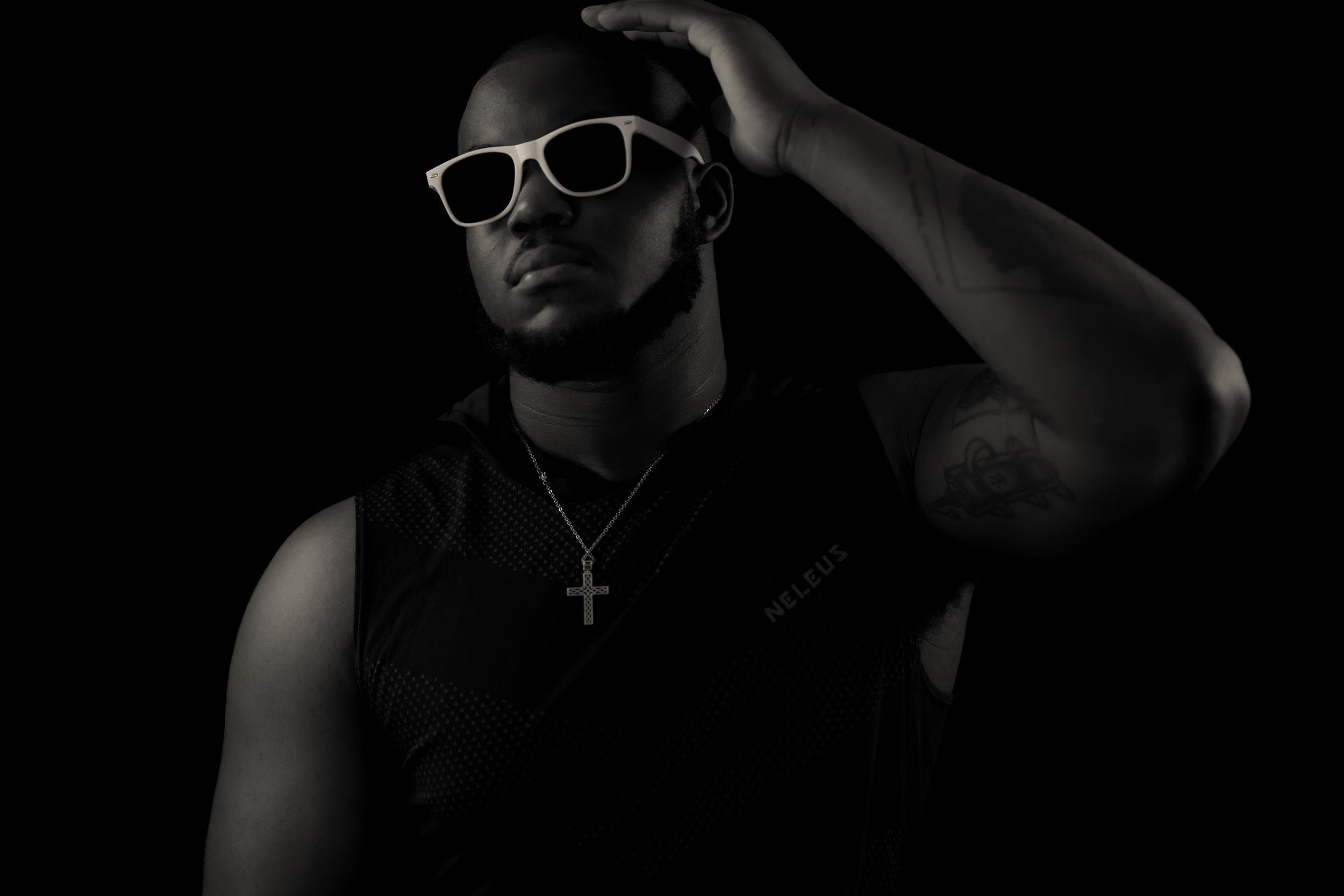 High contrast black and white image of figure wearing stylish white glasses.