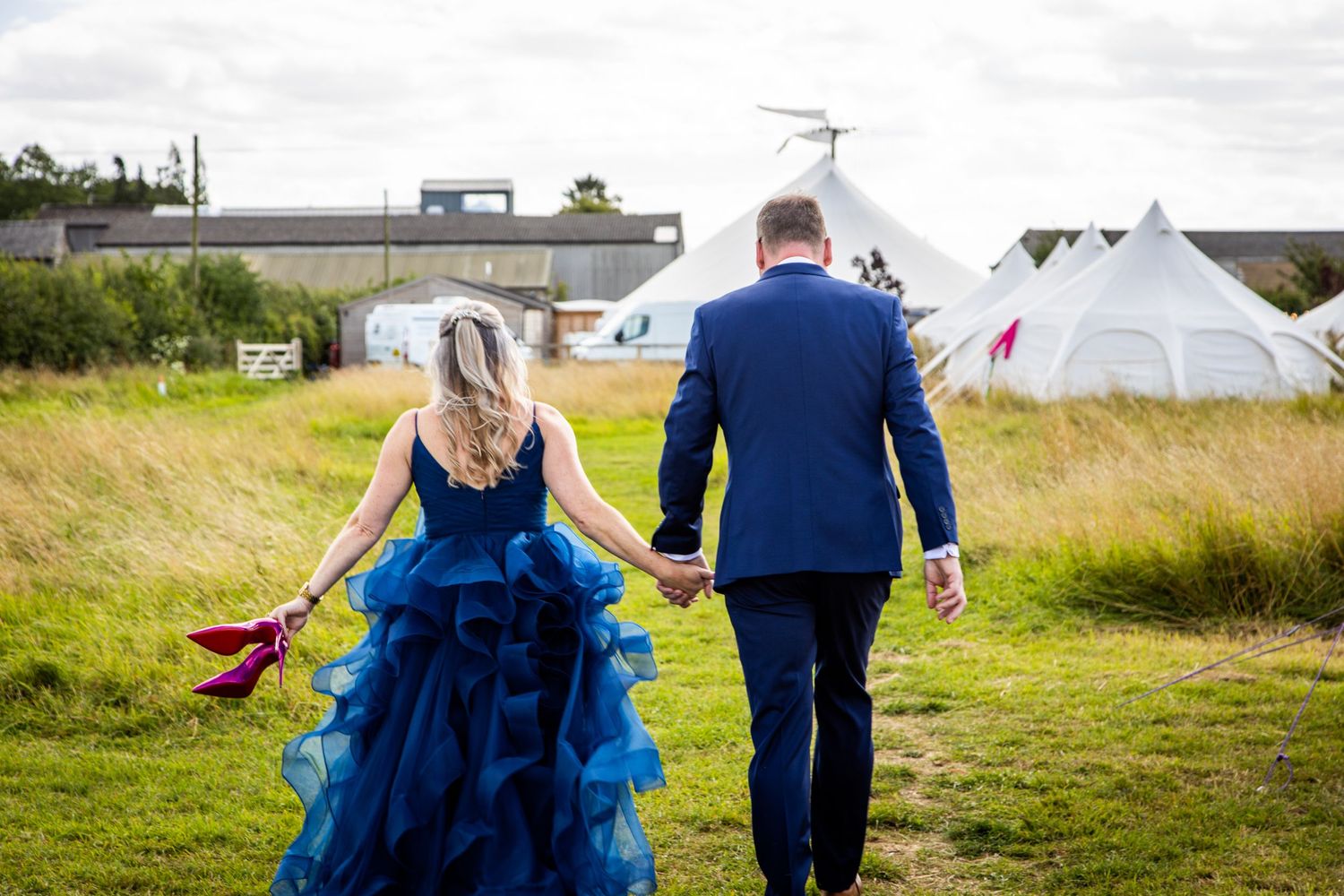 Bride in a blue dress with pink Louboutin stililettos in Chittering Farm near Cambridge wedding venue