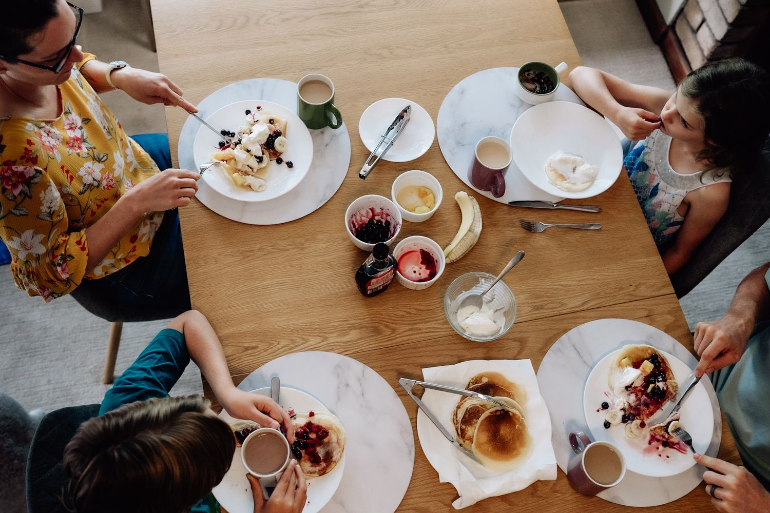 A Birds Eye image of a family eating breakfast in their home, during a relaxed family photo session