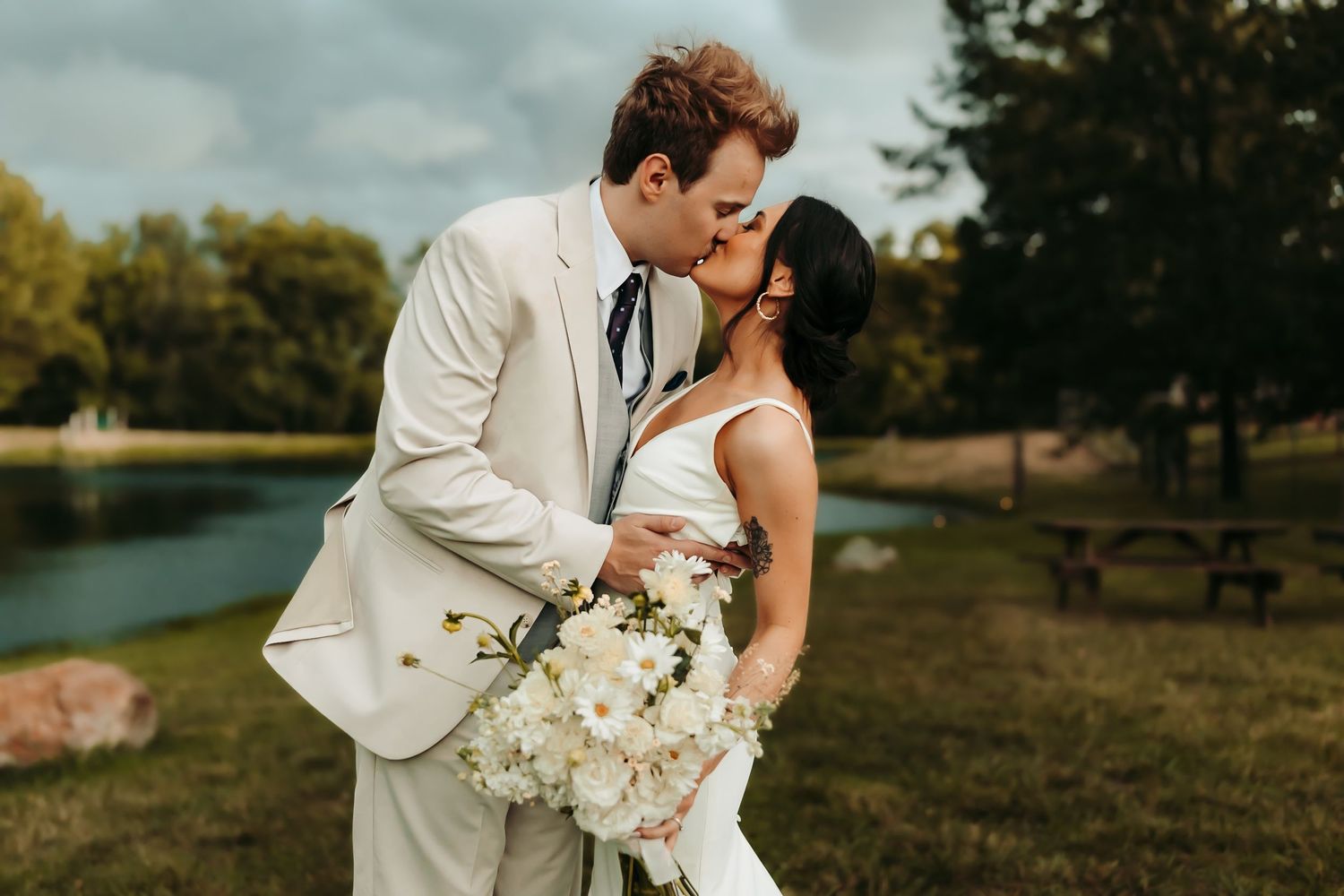 Wedding at Loveland Estates in Pocahontas, IL. Couple kissing by the water.