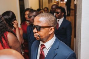 A guest in formal attire mingles during an elegant wedding celebration.