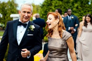 Candid wedding celebration moment captured outdoors with joyful expressions.