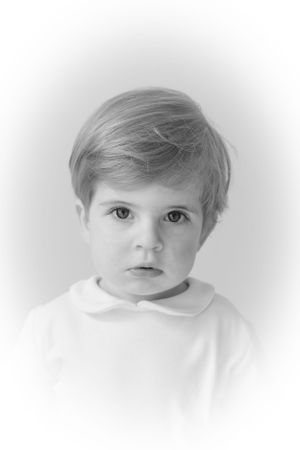 Black and white artistic portrait series showing child in white clothing.