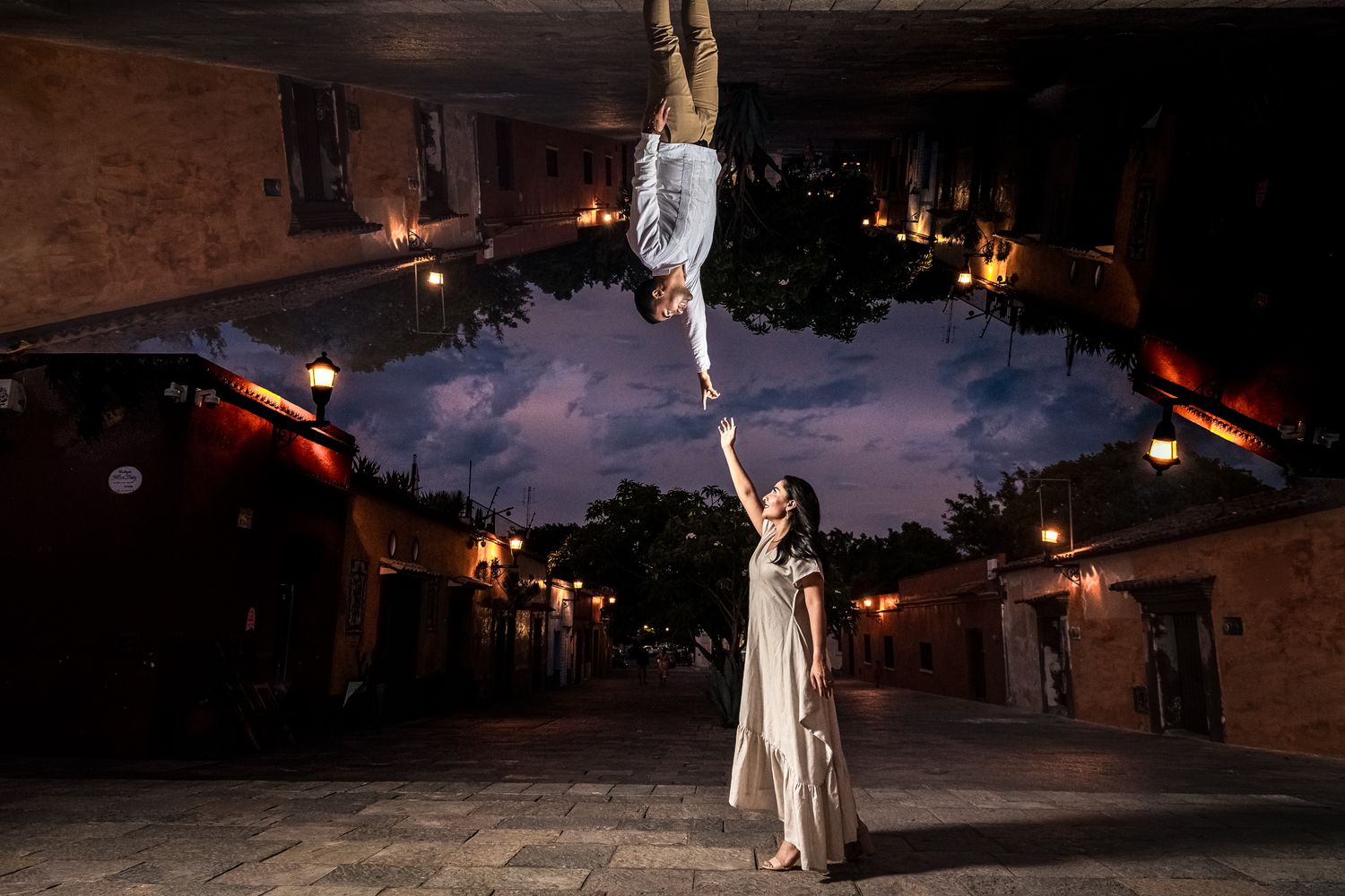 Dramatic sunset wedding portraits with couple silhouetted against colorful evening sky.
