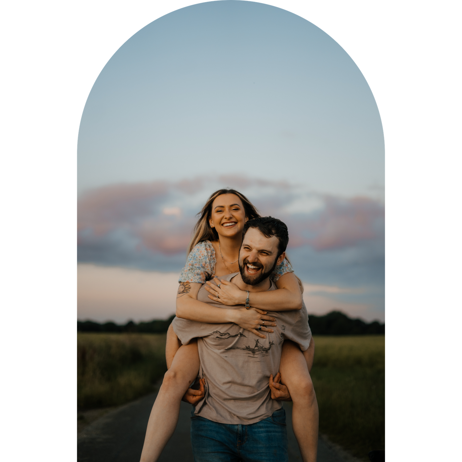 A joyful piggyback ride moment captured in a field at sunset.