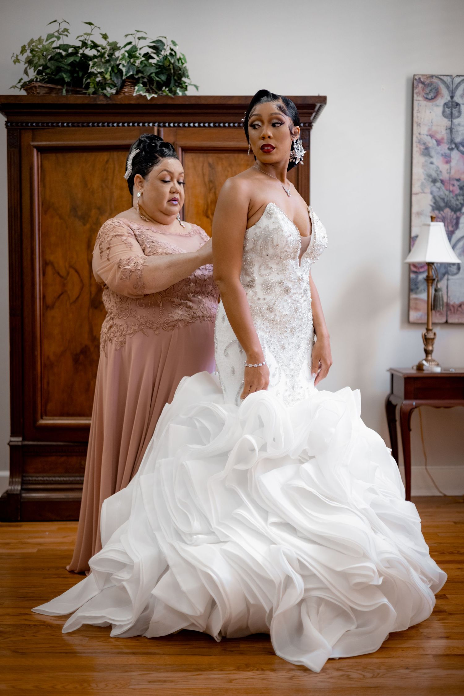 A stunning white mermaid wedding gown with intricate details and flowing ruffles.