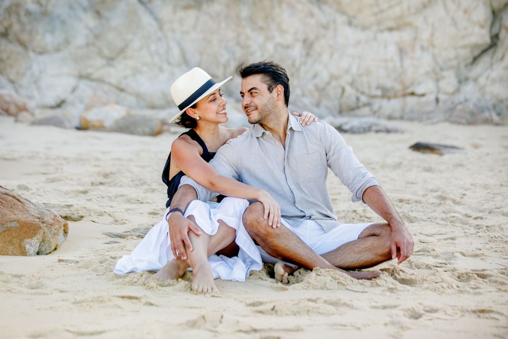 Intimate beach portraits captured on sandy shore at sunset.