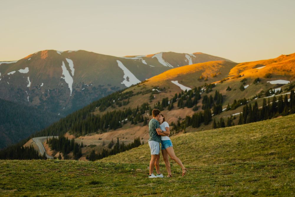 Bride and groom-to-be sharing a romantic kiss on top of Loveland pass on top of the Continental Divide