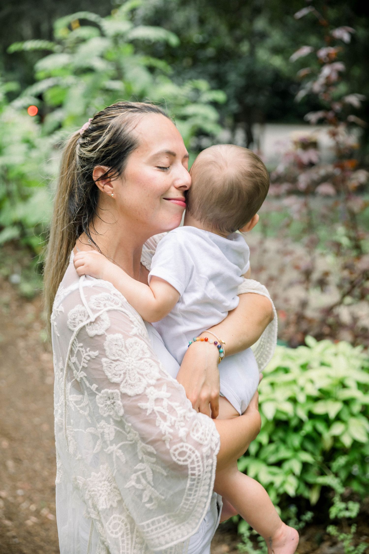 Intimate portrait series in a garden setting showing loving embraces among greenery.