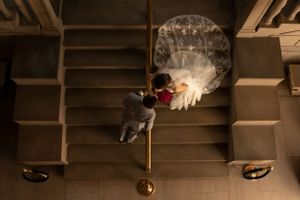 A creative overhead wedding photo on stairs with dramatic smoke effects.