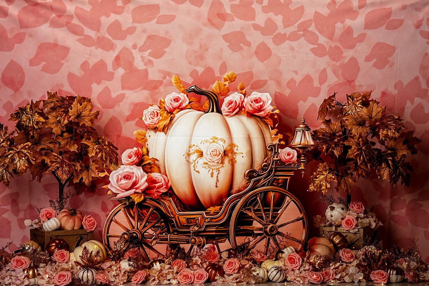 Autumn themed backdrop with pumpkins, roses and vintage carriage in warm coral tones.