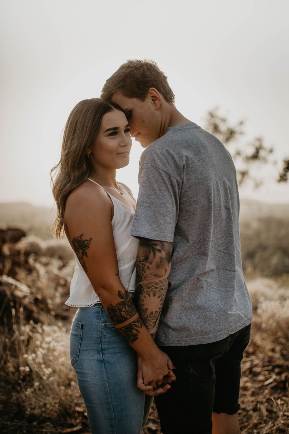 Man kissing woman on cheek on hill in Mount Isa