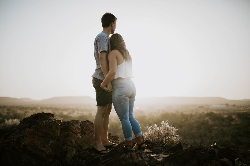Couple hugging at sunset on a hill in Mount Isa