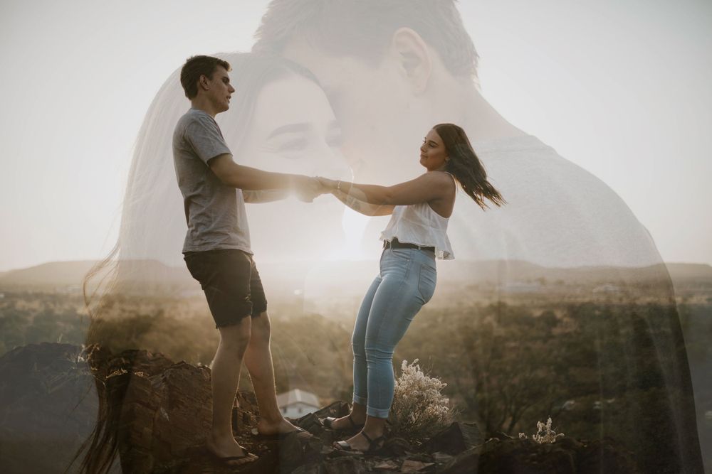 Double exposed image of couple on cliff