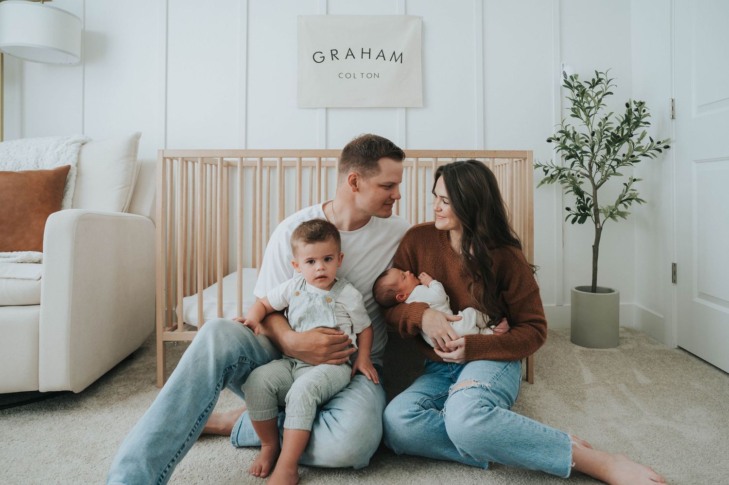 A family enjoys their newborn photoshoot in their own home with a talented local Lehi photographer