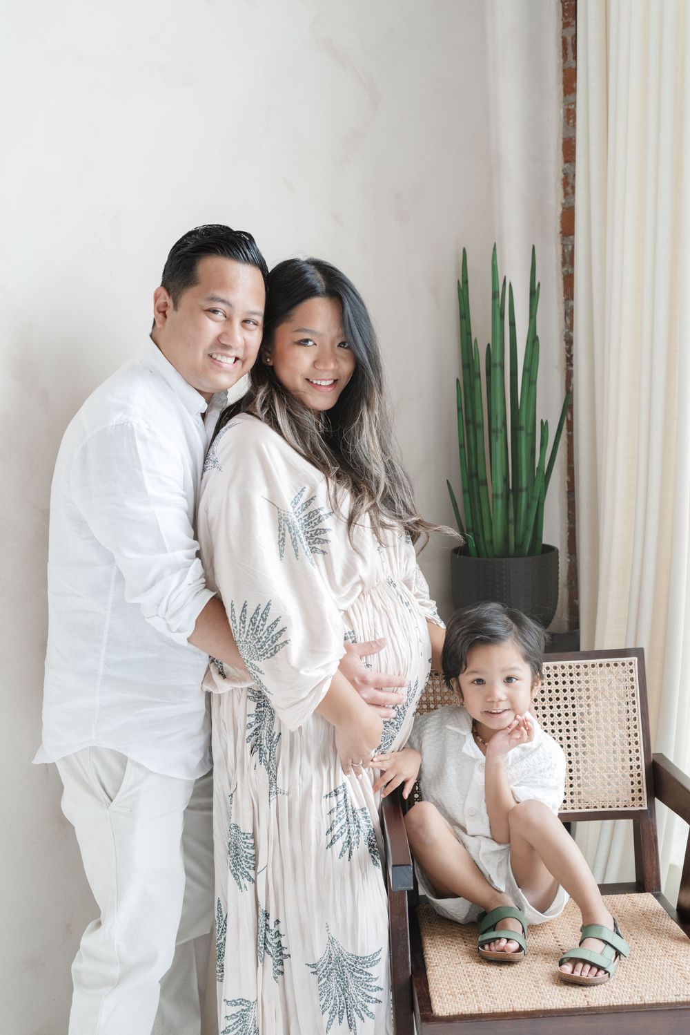 Toronto family posing for a maternity shoot at Mint Room Studios, with a toddler, photographed by Jess GC Photography