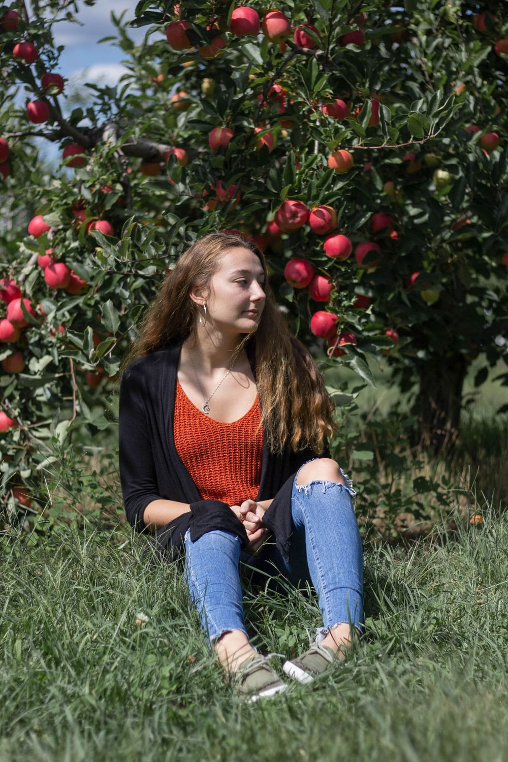 High school senior portrait in apple orchard
